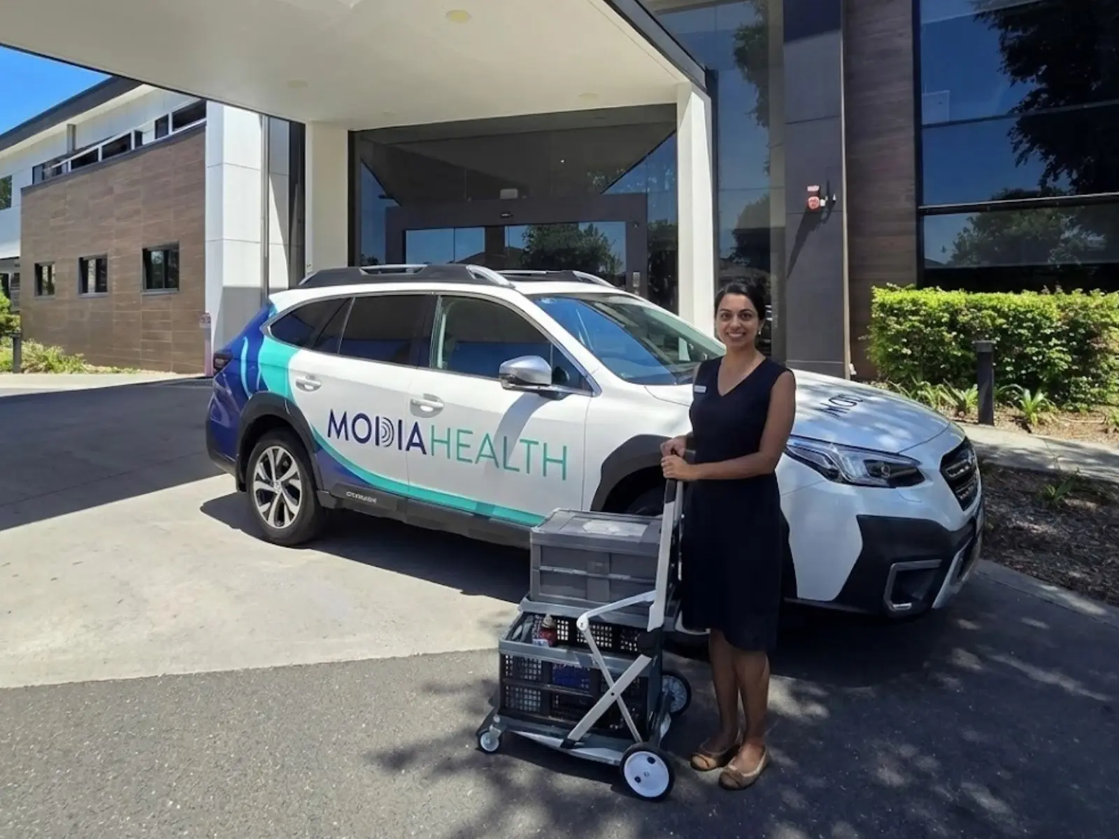Local business owner photographed with her branded work vehicle