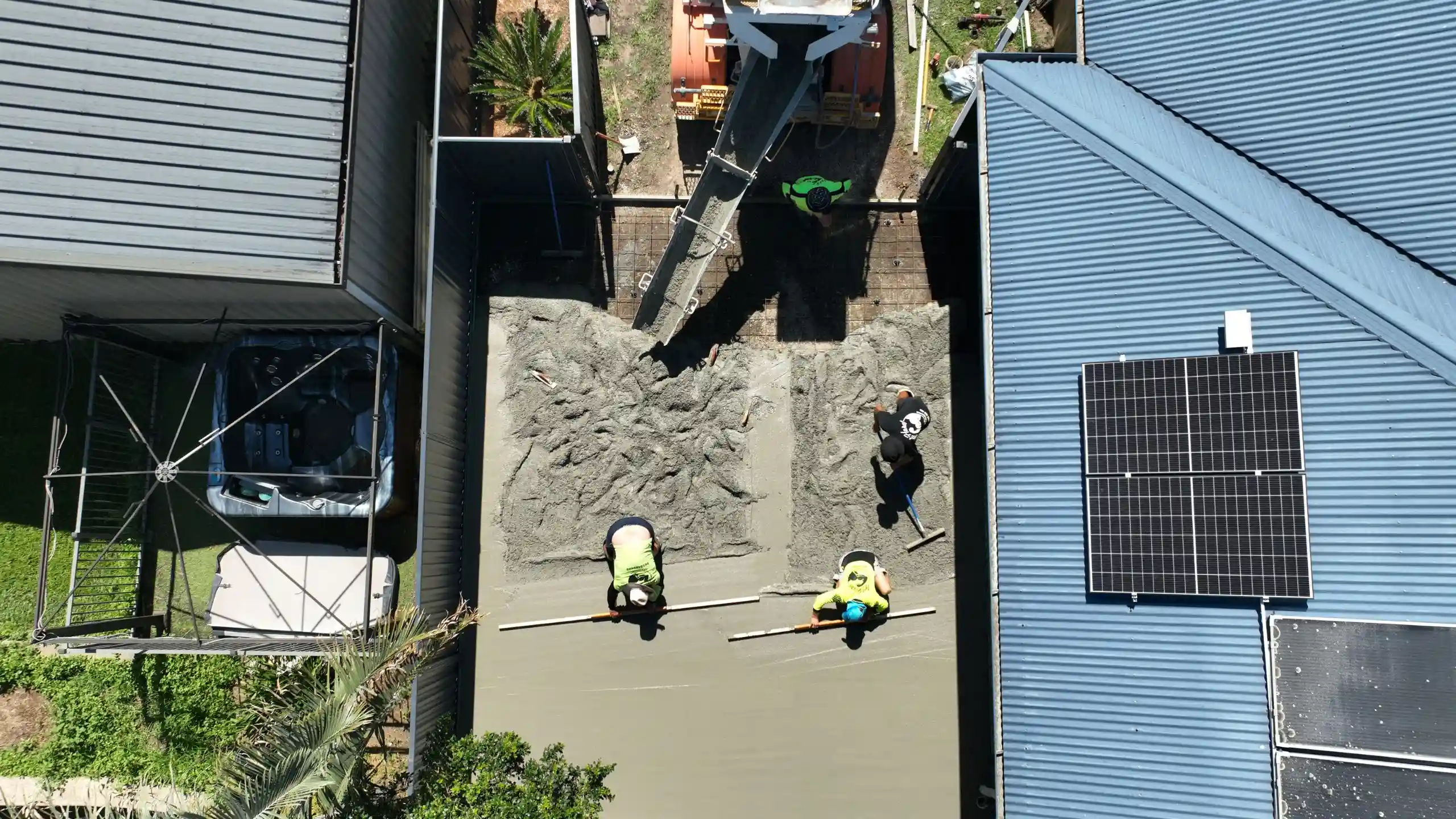 A Brisbane concrete crew photographed from above while pouring and finishing a slab